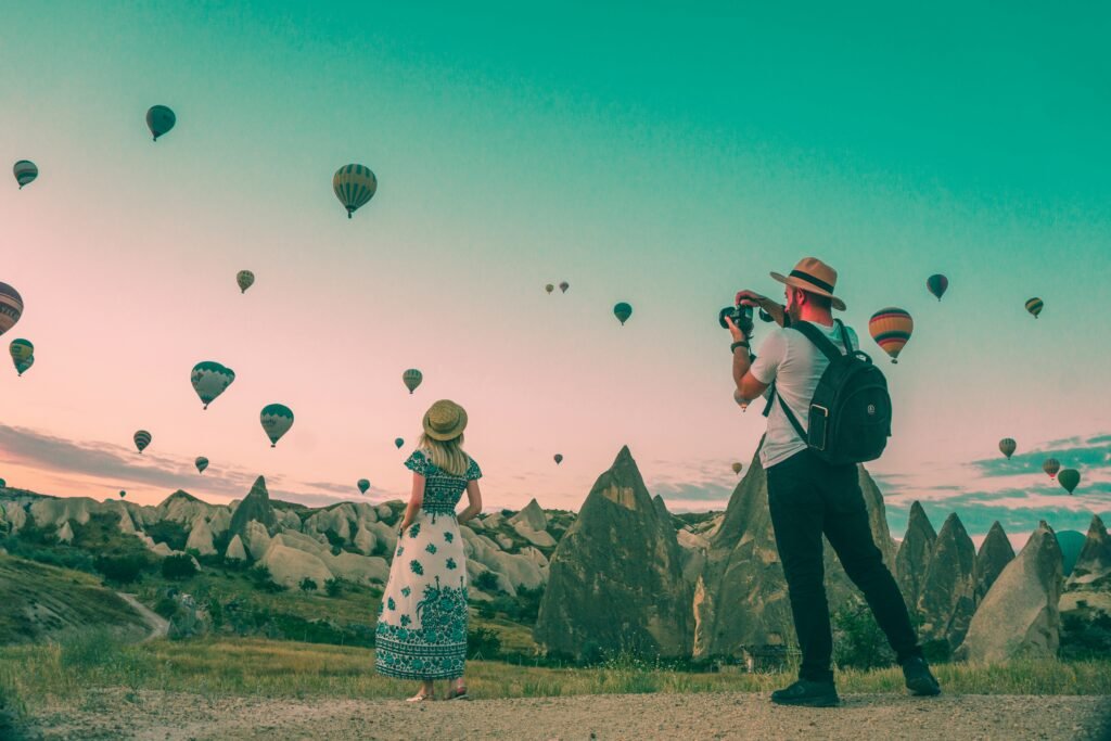 Man Taking Photo of Hot Air Balloons for Tourist Attractiveness