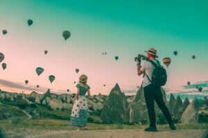 Man Taking Photo of Hot Air Balloons for Tourist Attractiveness
