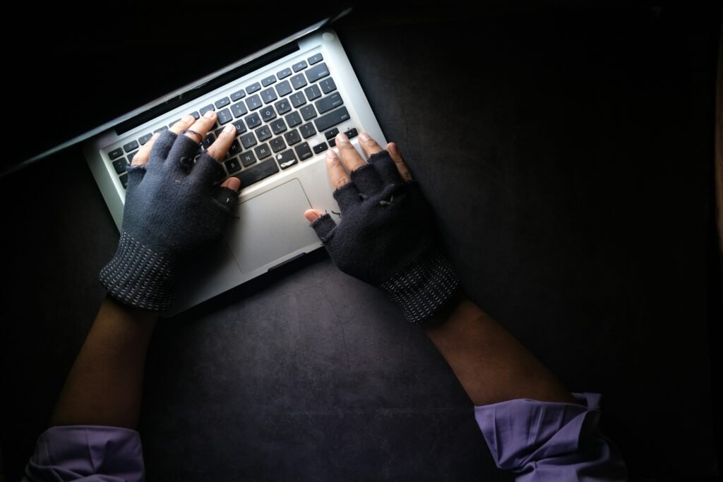 Online Identity Theft - Laptop and hands with gloves